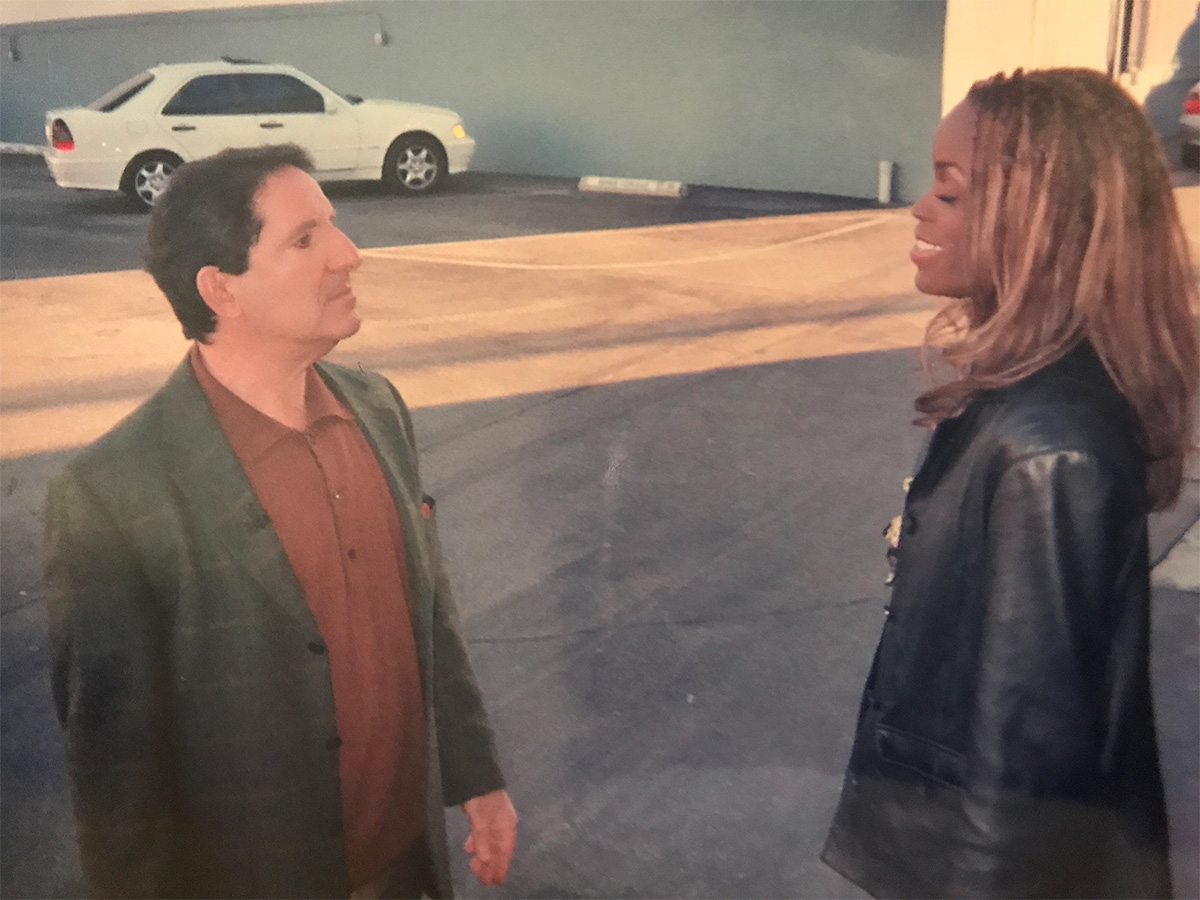 Arthur Joseph instructs Dot Todman outside KTLA parking lot before performing on TV singing competition, where she wins first prize.